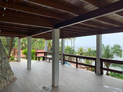 a porch with a view of the ocean at Casa Carabela, Omoa, Cortes in Omoa