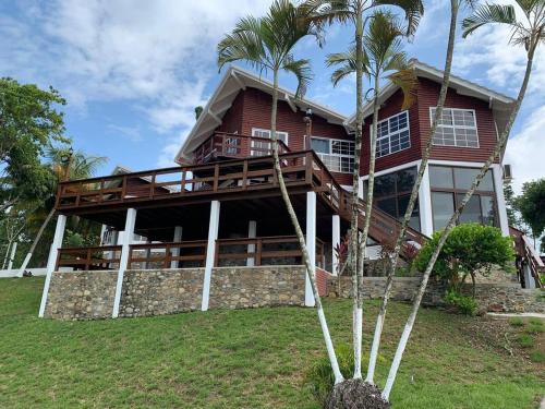 a house with palm trees in front of it at Casa Carabela, Omoa, Cortes in Omoa