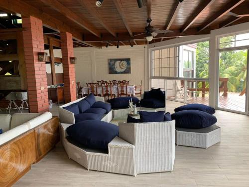 a living room with couches and blue pillows at Casa Carabela, Omoa, Cortes in Omoa