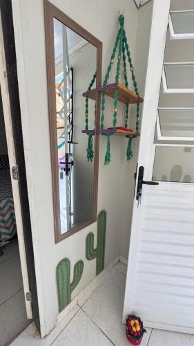 a door to a house with a cactus painting on the wall at L1 localize casa na praia in Fortim