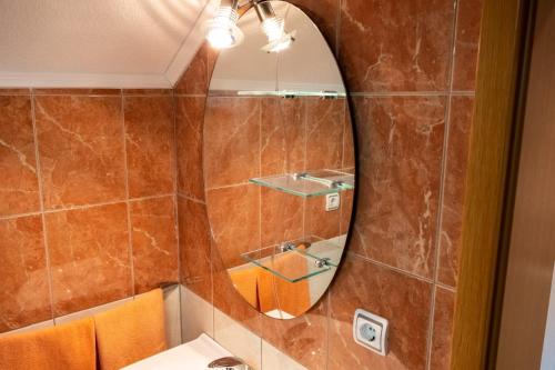 a bathroom with a mirror and a sink at Apartman KIKI in Kupres
