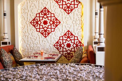 a dining room with a table and red and white wall at Radisson Blu Resort & Thalasso Hammamet in Hammamet