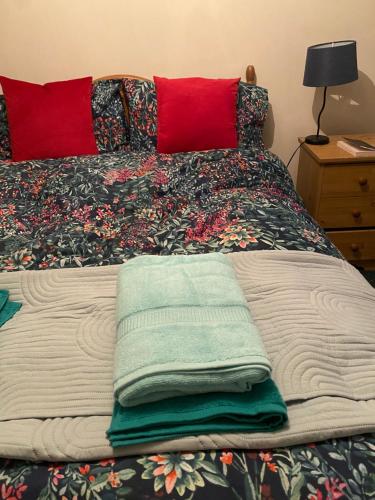 a bed with two towels on top of it at Tigh George in Lettermore