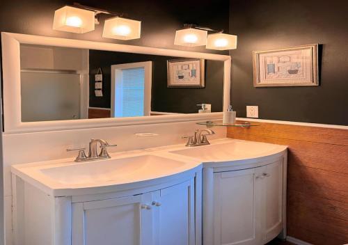 a bathroom with two sinks and a large mirror at See NY Now Sleeps 21 in Union City