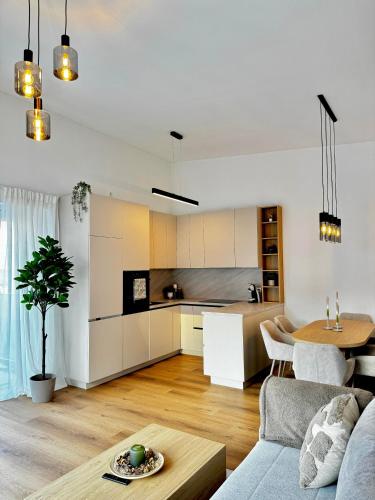 a kitchen and living room with a couch and a table at MiHome - modern Living in Rottenmann