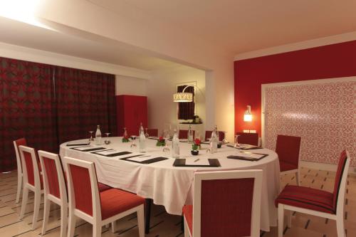 a dining room with a white table and chairs at Radisson Blu Resort & Thalasso Hammamet in Hammamet