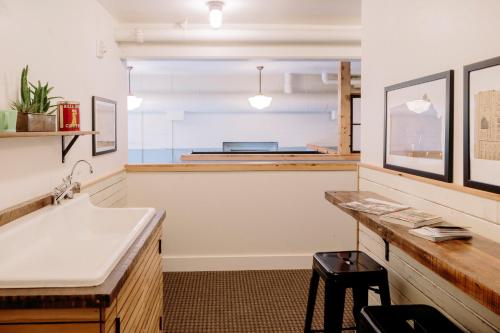 a kitchen with a sink and a counter top at The Society Hotel in Portland