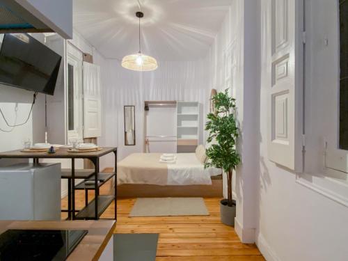 a living room with a bed and a table and a dining room at Victoria Studio III in Madrid