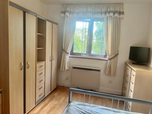 a bedroom with a bed and a window at West-London minimalism with parking on premises in London