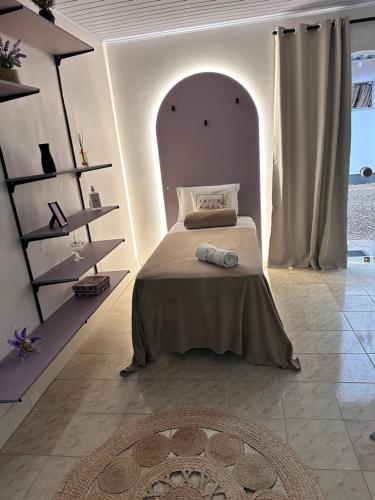a bedroom with a bed in a white room at La Vita studio Lavanda in Nova Veneza