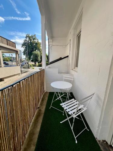 une table et deux chaises sur un balcon dans l'établissement Casa Grivel #1 - T2 avec Clim et Balcon - Centre Ville, à Brive-la-Gaillarde