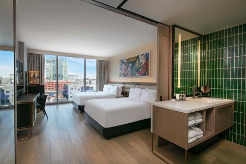 a hotel room with two beds and a desk at W Nashville in Nashville