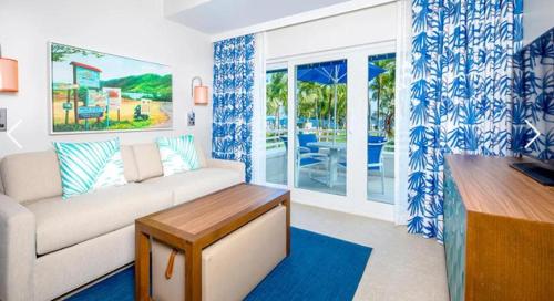 a living room with a couch and a table at St Thomas Luxury Beach Resort in Nazareth