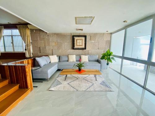 a living room with a couch and a table at Casa Luna Suites-4 in Monterrey