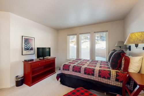 a bedroom with a bed and a tv on a dresser at Christy Lane Condo in Olympic Valley
