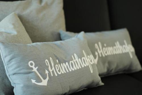 a pillow with the word anniversary written on it at Sonnengarten 20 - Heimathafen in Kellenhusen