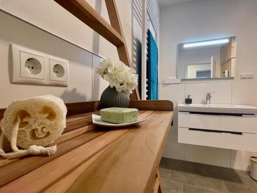 a bathroom with a counter with a cake and a sink at Sonnenweg 46-6 WILDE 13 in Heringhausen