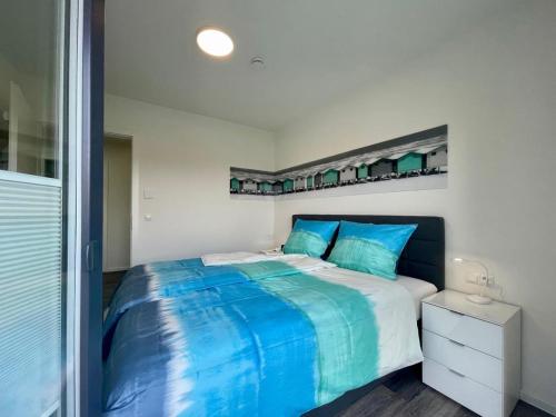 a bedroom with a large bed with blue sheets at Sonnenweg 18 in Heringhausen
