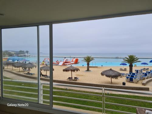 a view of a beach from a window at San Alfonso del Mar Departamentos in Algarrobo