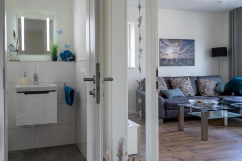a living room with a couch and a table at Ferienhaus SONNENWEG 16 in Heringhausen