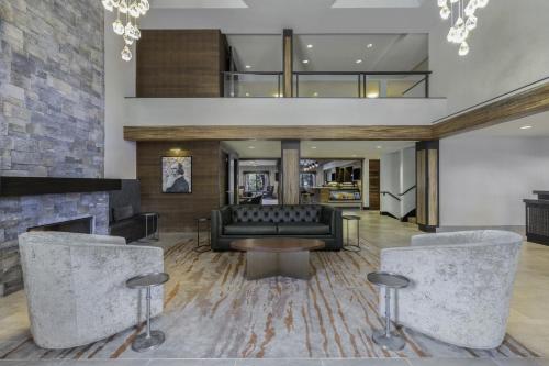 a living room with a couch and a fireplace at The Newberry Hotel Bend, Tapestry Collection by Hilton in Bend