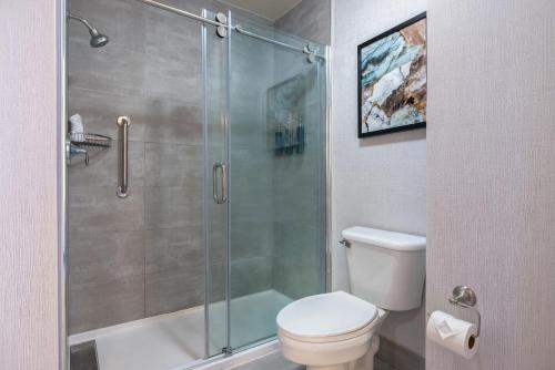 a bathroom with a toilet and a glass shower at The Newberry Hotel Bend, Tapestry Collection by Hilton in Bend