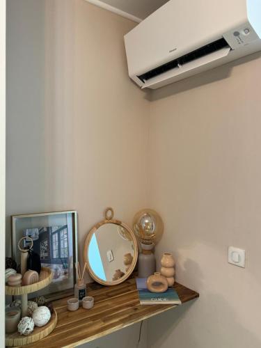a mirror on a shelf in a room at Bandol A Bandol cha cha cha - Appartement in Bandol