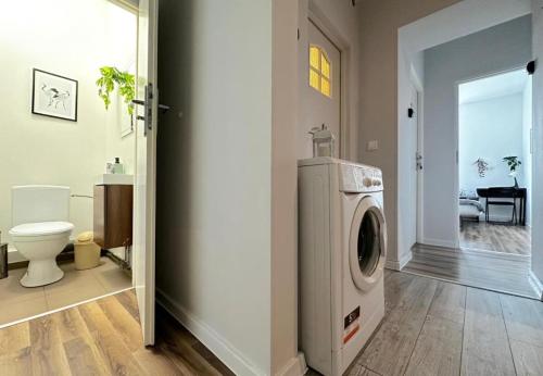 a bathroom with a washer and dryer in a room at Morska Water Massage Room 4 in Gdynia