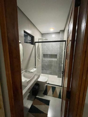 a bathroom with two sinks and a toilet and a shower at Encanto da Barra Pousada in Barra Grande