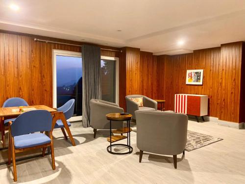 a living room with a table and chairs at Sky Lodge Hotel in Nathia Gali