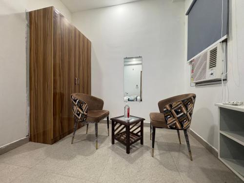 a waiting room with two chairs and a table at Radiant Blu Hotel in Noida