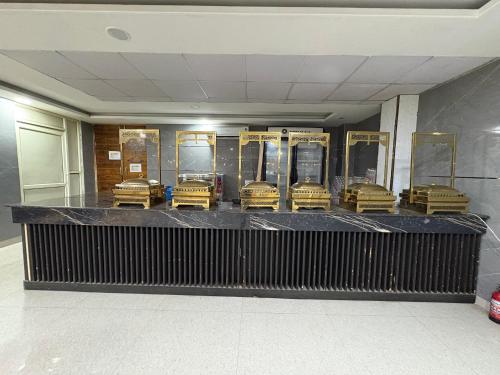 a baggage claim in a building with gold luggage at Radiant Blu Hotel in Noida