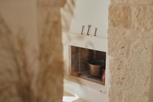 a brick oven with a pot inside of it at Borgo Petra - with heated pool in Cisternino