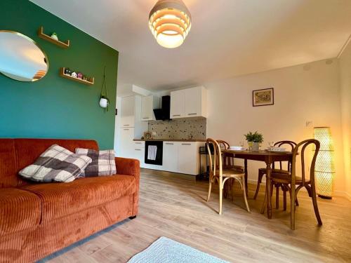 a living room with a couch and a table at La Grange - Ground Floor Apartment, Terrace, Free Private Parking, Near Colmar in Sainte-Croix-en-Plaine