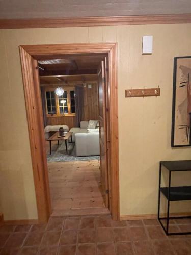 a hallway leading into a living room with a door at Marvelous farmhouse with WiFi in Troms, Northern Norway in Nordøya