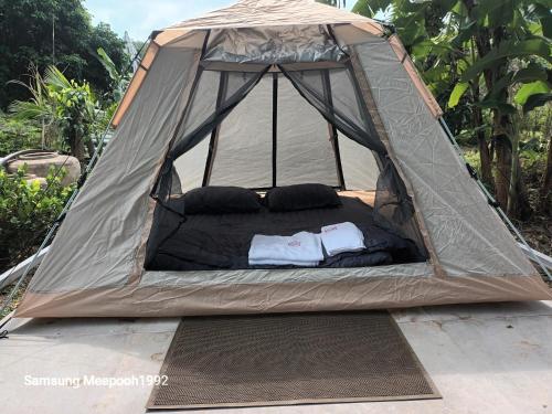 a tent with two pillows and a bed in it at PhaluayCamping in Koh Phaluai