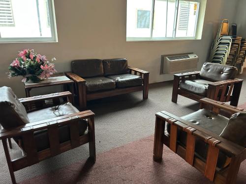 a living room with leather furniture and a couch at Glenwood Inn - Stroudsburg in Delaware Water Gap