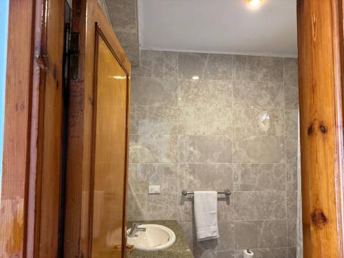 a bathroom with a sink and a toilet and a mirror at Sun Beach Hotel Safaga in Hurghada