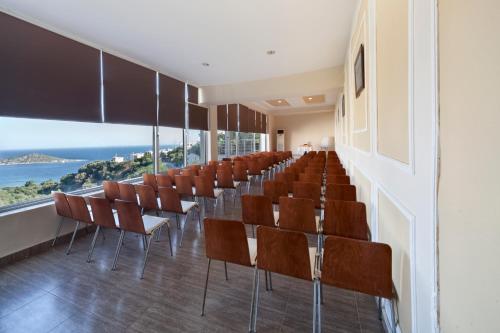 a row of chairs in a room with a view at Crystal Hotel Bodrum in Gumusluk