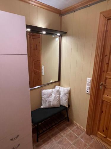 a small room with a mirror and a chair at Marvelous farmhouse with WiFi in Troms, Northern Norway in Nordøya