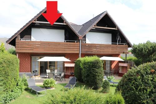 a house with a red arrow on top of it at Appartement 11 in Scharbeutz