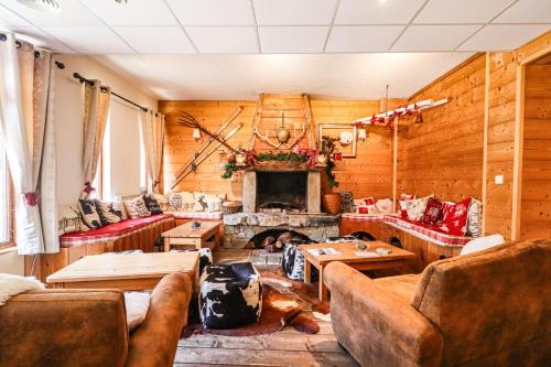 a living room with couches and a fireplace at Domaine de l'Adoux in Saint-Jean Montclar