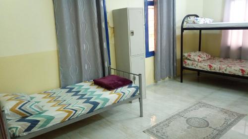 a room with a bunk bed in a room at SALEM House Hostel Nizwa in Nizwa