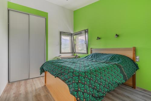a green bedroom with a bed and two windows at Villa Plein la vue en 360° in Coublevie
