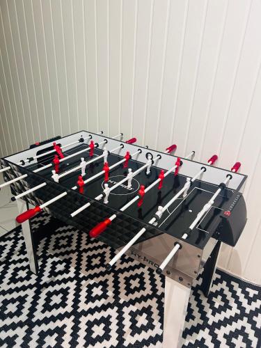 a ping pong table with a group of people on it at Waterside Stay- 3 Bed House- Sleeps 5- Parking- Fast Wifi in Burton upon Trent
