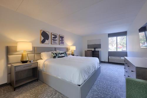 a bedroom with a large white bed and a desk at Lititz Pointe Inn and Suites in Lititz