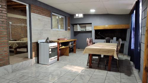 a kitchen with a table and a kitchen with a dining room at Cabañas misueño in Villa Ciudad de America