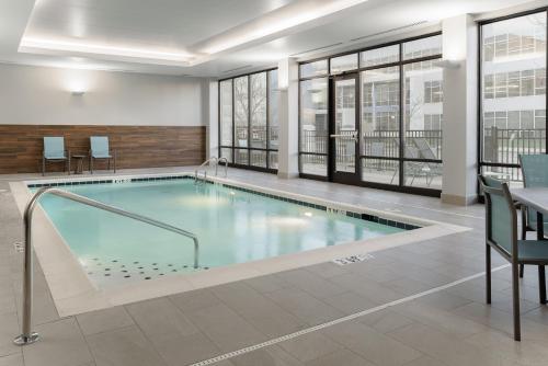 a large swimming pool in a building with windows at Fairfield by Marriott Inn & Suites Cincinnati Oakley in Cincinnati
