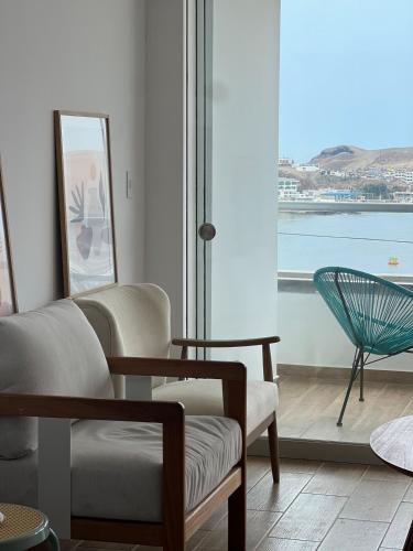 a living room with a view of the ocean at Ocean View Premiere Depa Naplo in Naplo
