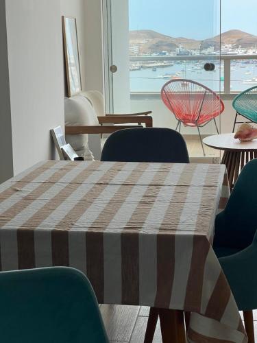 a table and chairs in a room with a view at Ocean View Premiere Depa Naplo in Naplo